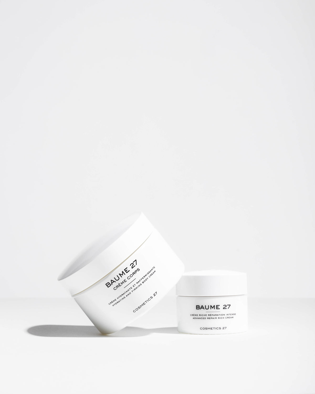 Tilted jar of Baume 27 Body Cream beside a smaller jar of Baume 27 Rich Cream