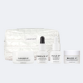 Cleanser 27, Essence 27, Huile 27 and Baume 27 Rich Cream in front of a white quilted pouch