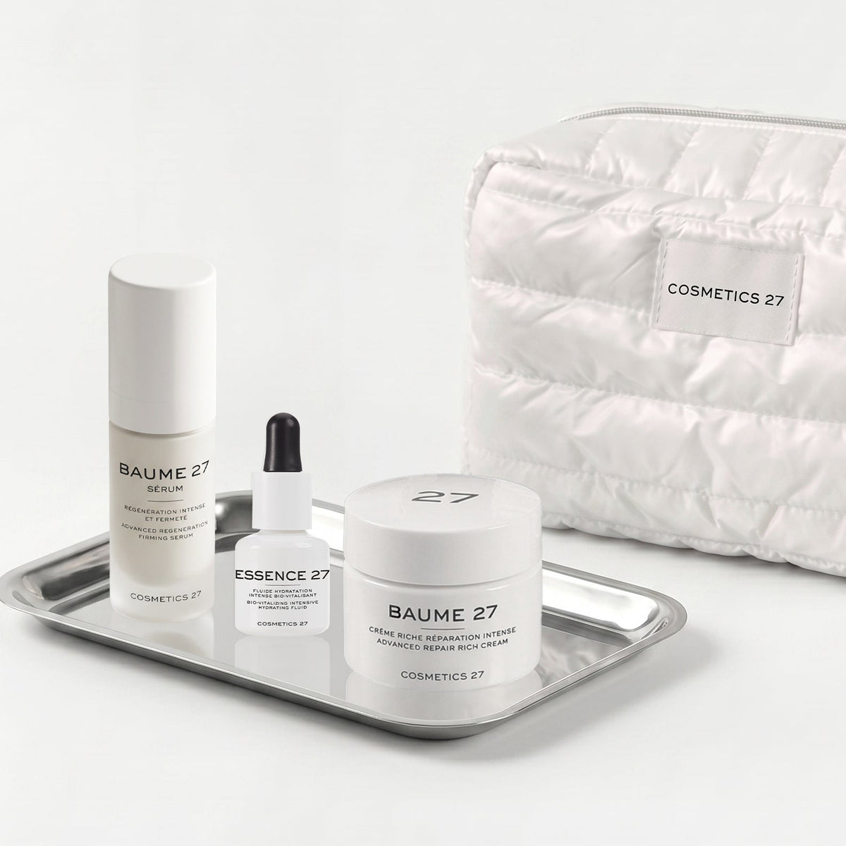 Baume 27 Serum, Essence 27 and Baume 27 Rich Cream on a silver tray, quilted pouch behind