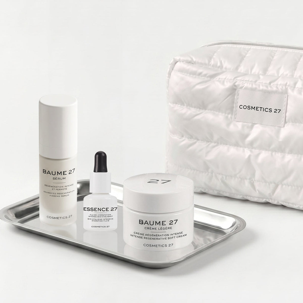 Baume 27 Serum, Essence 27 and Baume 27 Soft Cream on a silver tray, quilted pouch behind